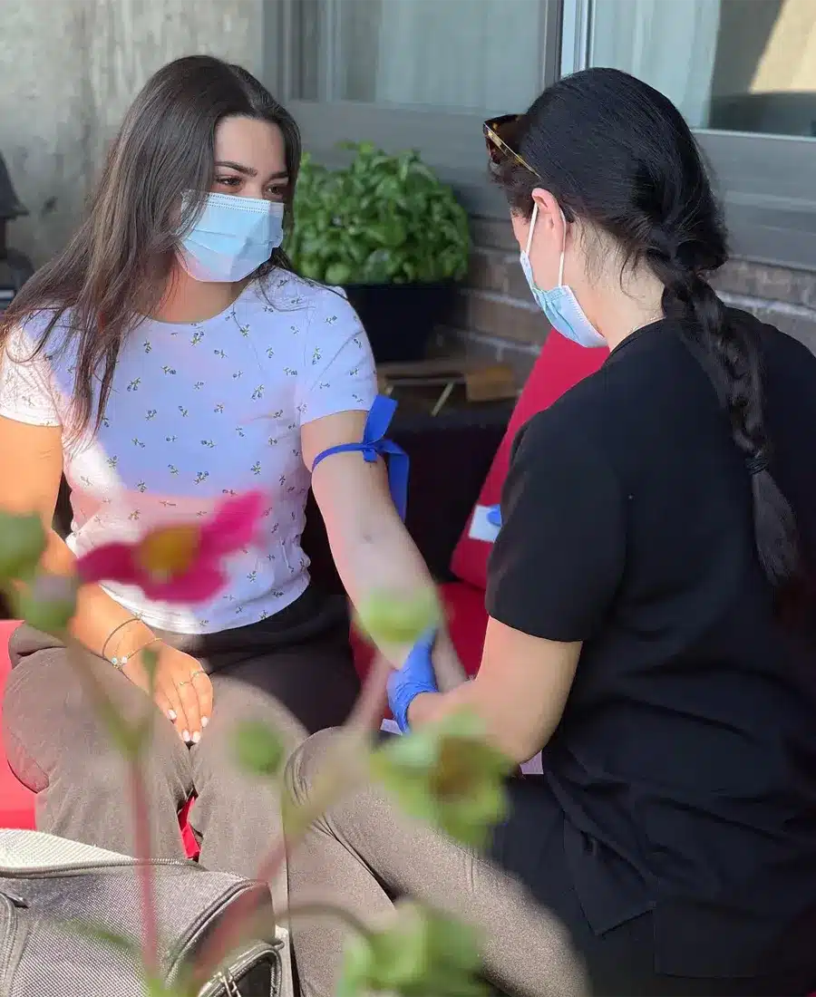 a nurse from Nela Sante providing medical attention to a patient through their mobile nursing Services in Westmount